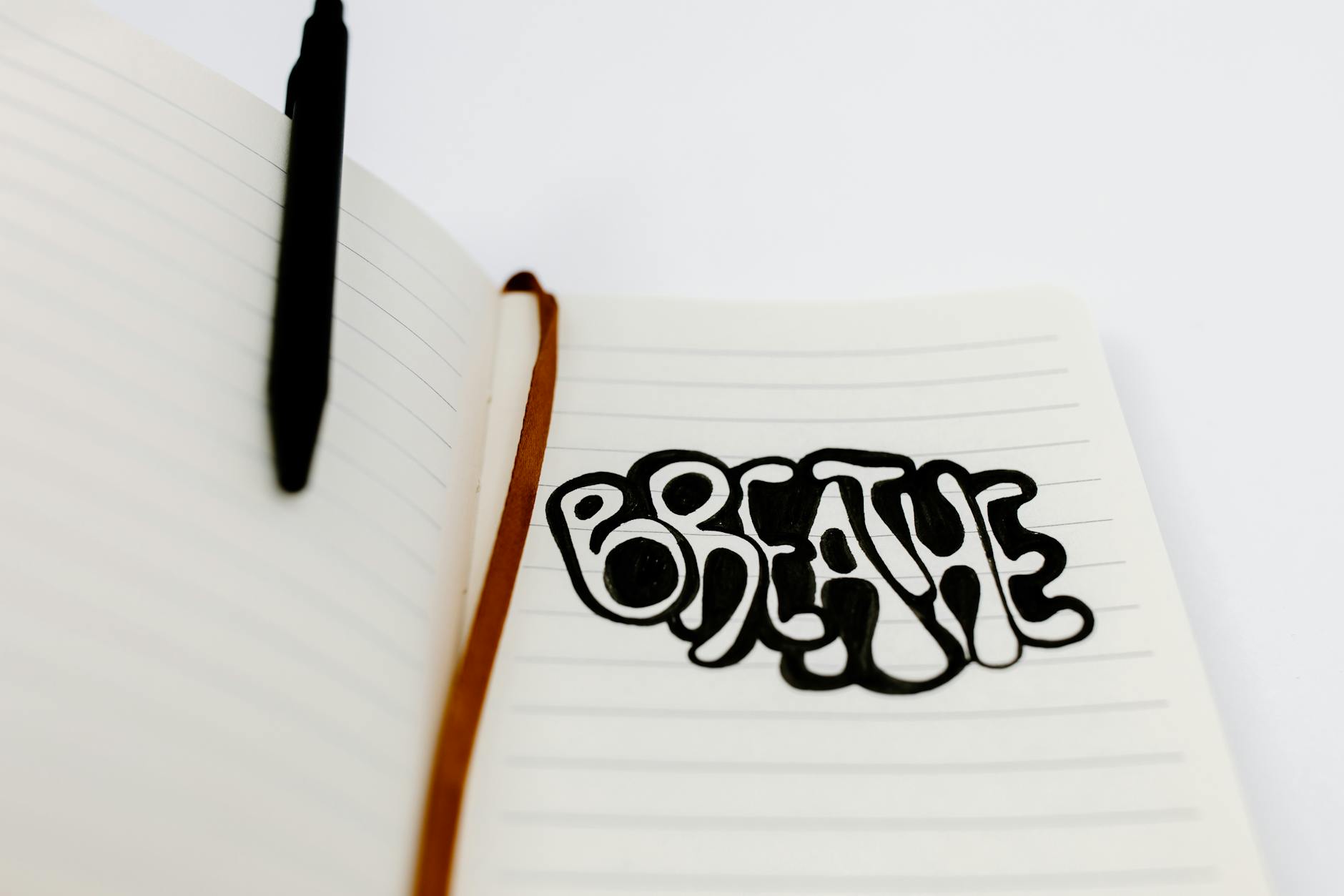 Dziennik oddechu: prosty sposób, by zauważyć, co naprawdę Cię stresuje Słowo Breathe zapisane odręcznie w notesie jako przypomnienie o oddechu